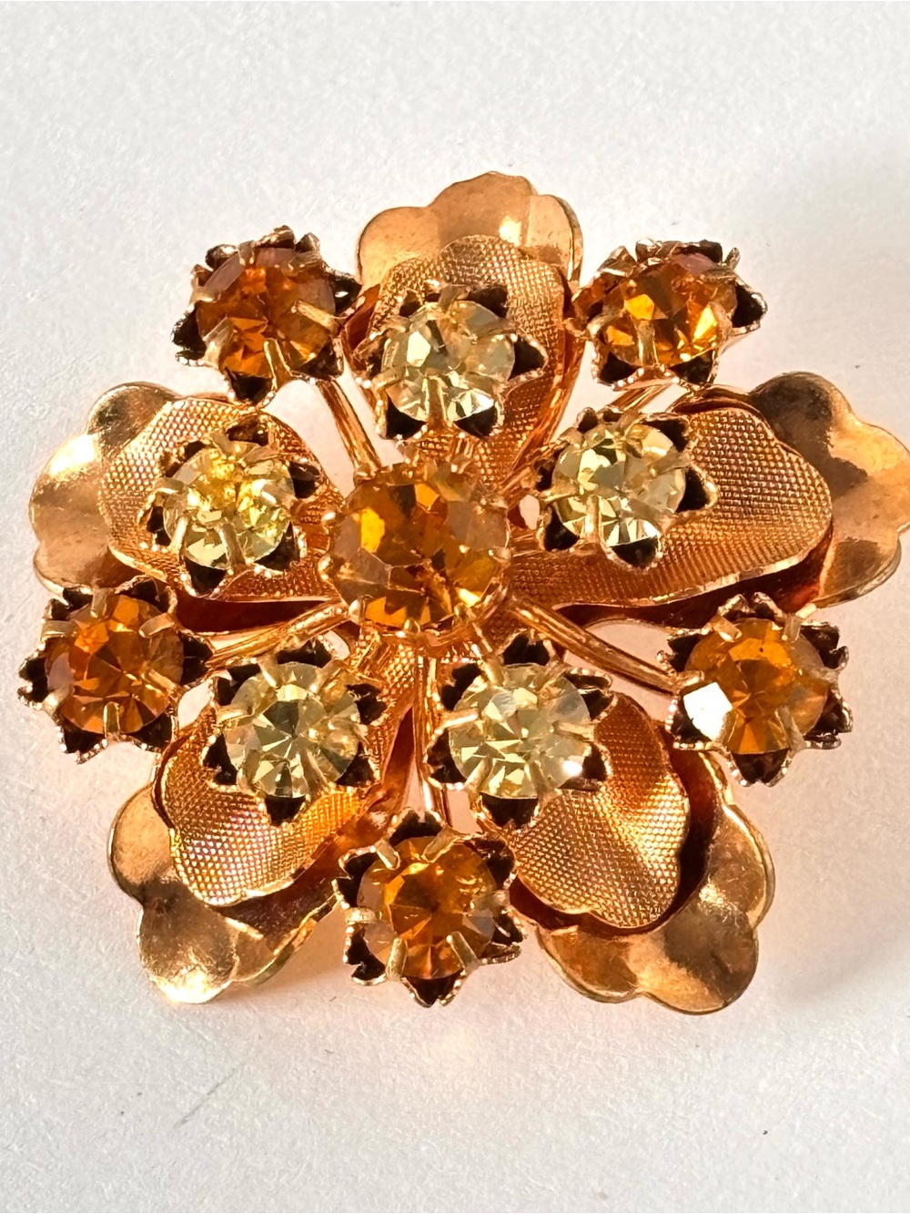 Vintage gold tone flower brooch with yellow and orange rhinestones